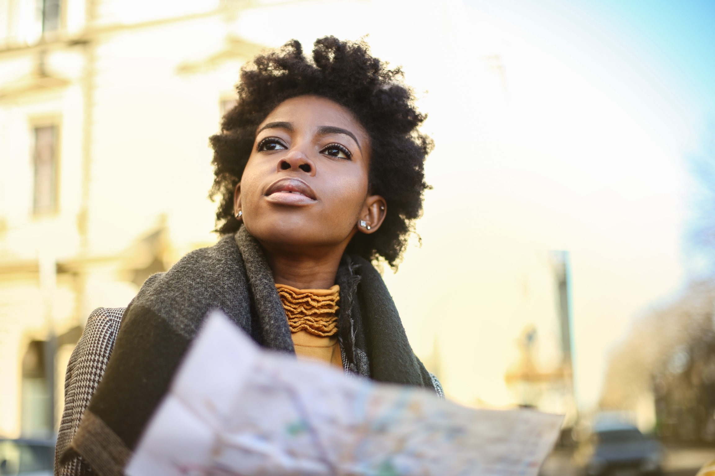 woman planning her trip outdoors with city map 2026 03 18 09 46 31 utc
